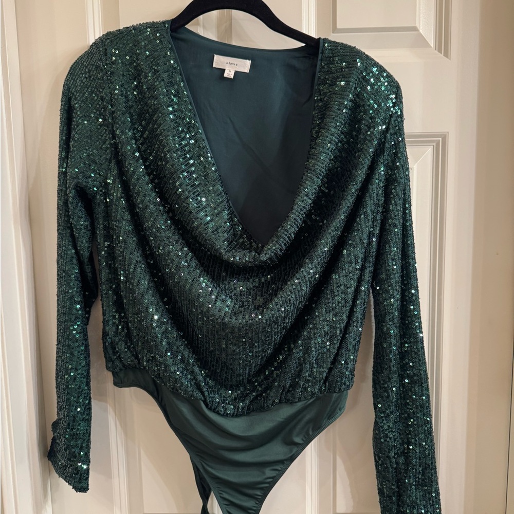 Ladies green sequined bodysuit with cowl neck.  Shoulder pads.